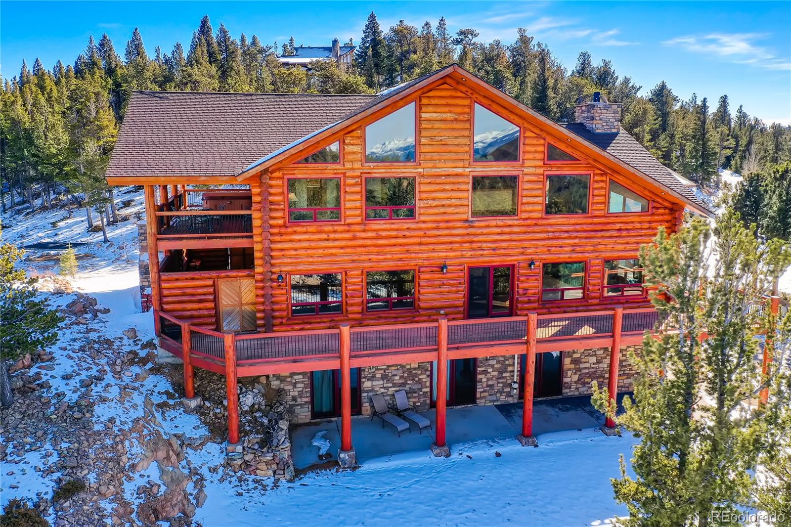 a backyard of a house with wooden deck and seating space