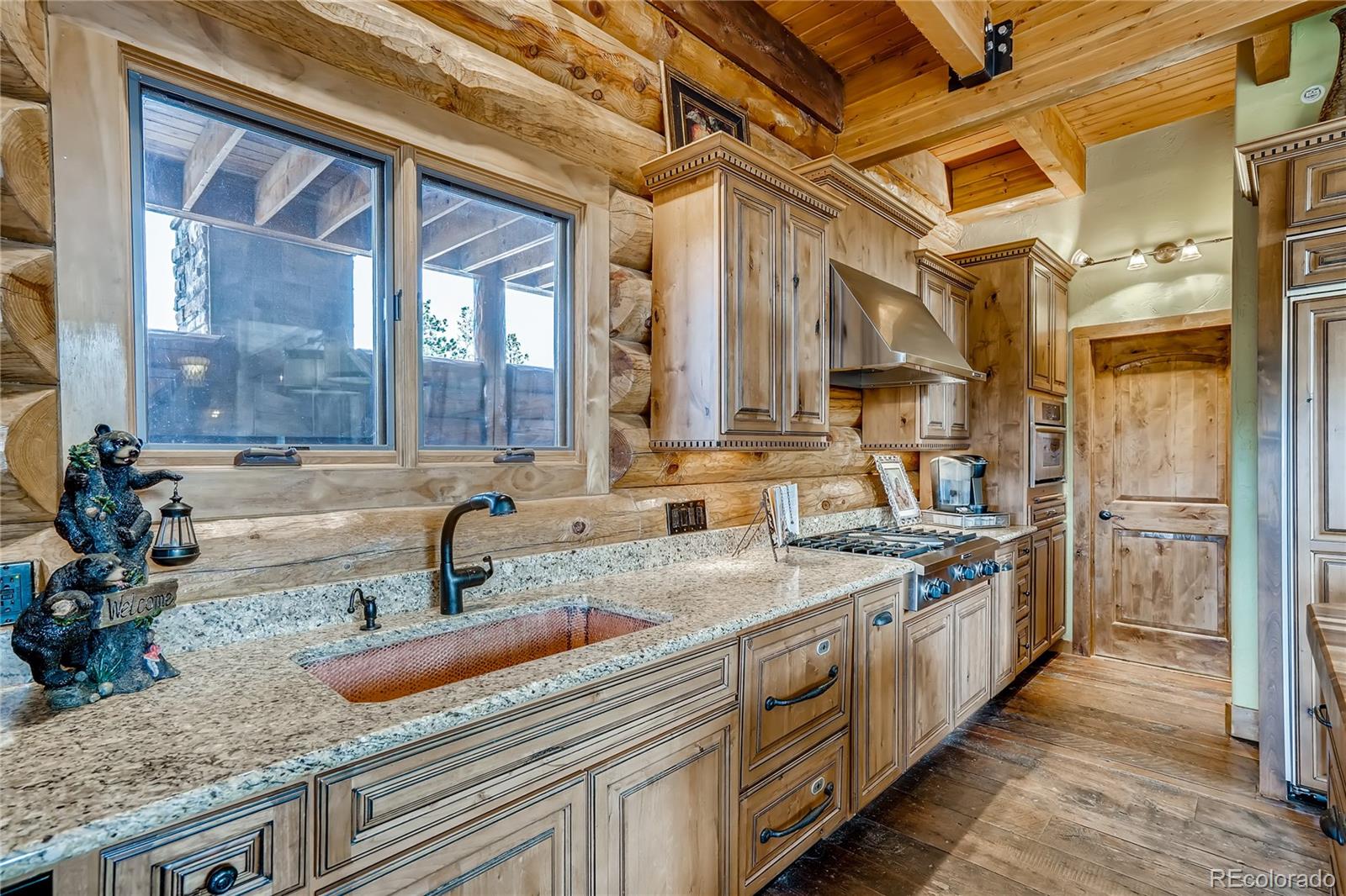 11200 Shimley Road Golden, CO 80403 - Photo 11 of 40 a kitchen with stainless steel appliances granite countertop a sink a stove and a wooden floors