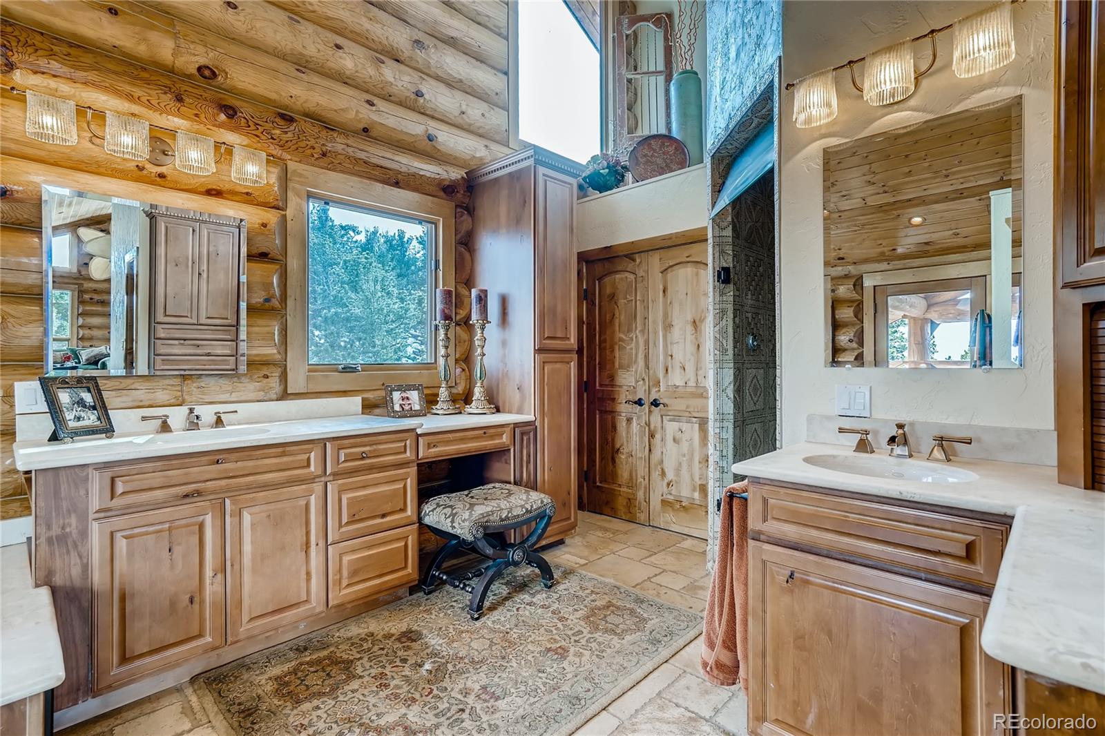 11200 Shimley Road Golden, CO 80403 - Photo 22 of 40 a spacious bathroom with a sink double vanity and a mirror