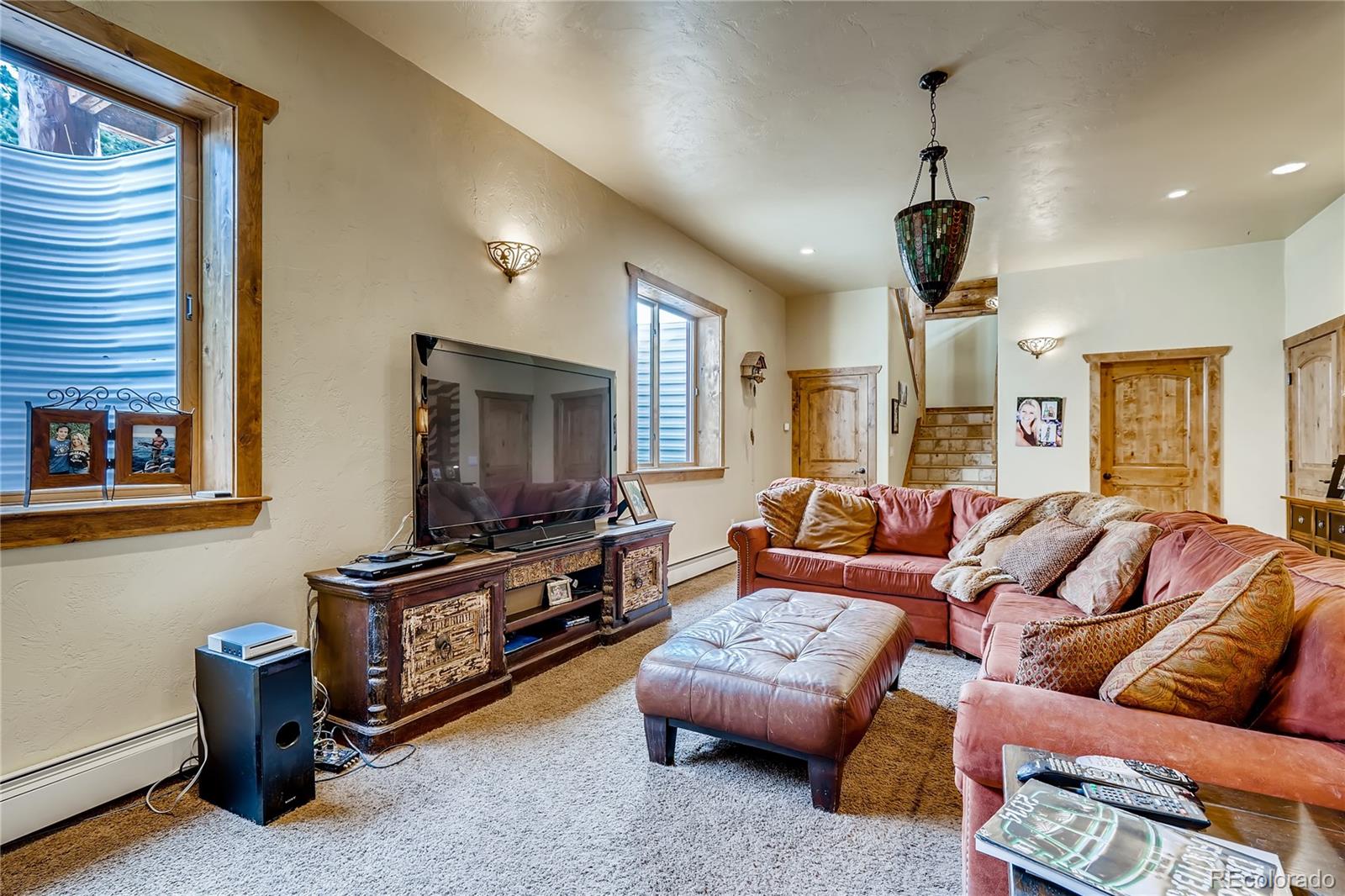 11200 Shimley Road Golden, CO 80403 - Photo 26 of 40 a living room with furniture ceiling fan and a window