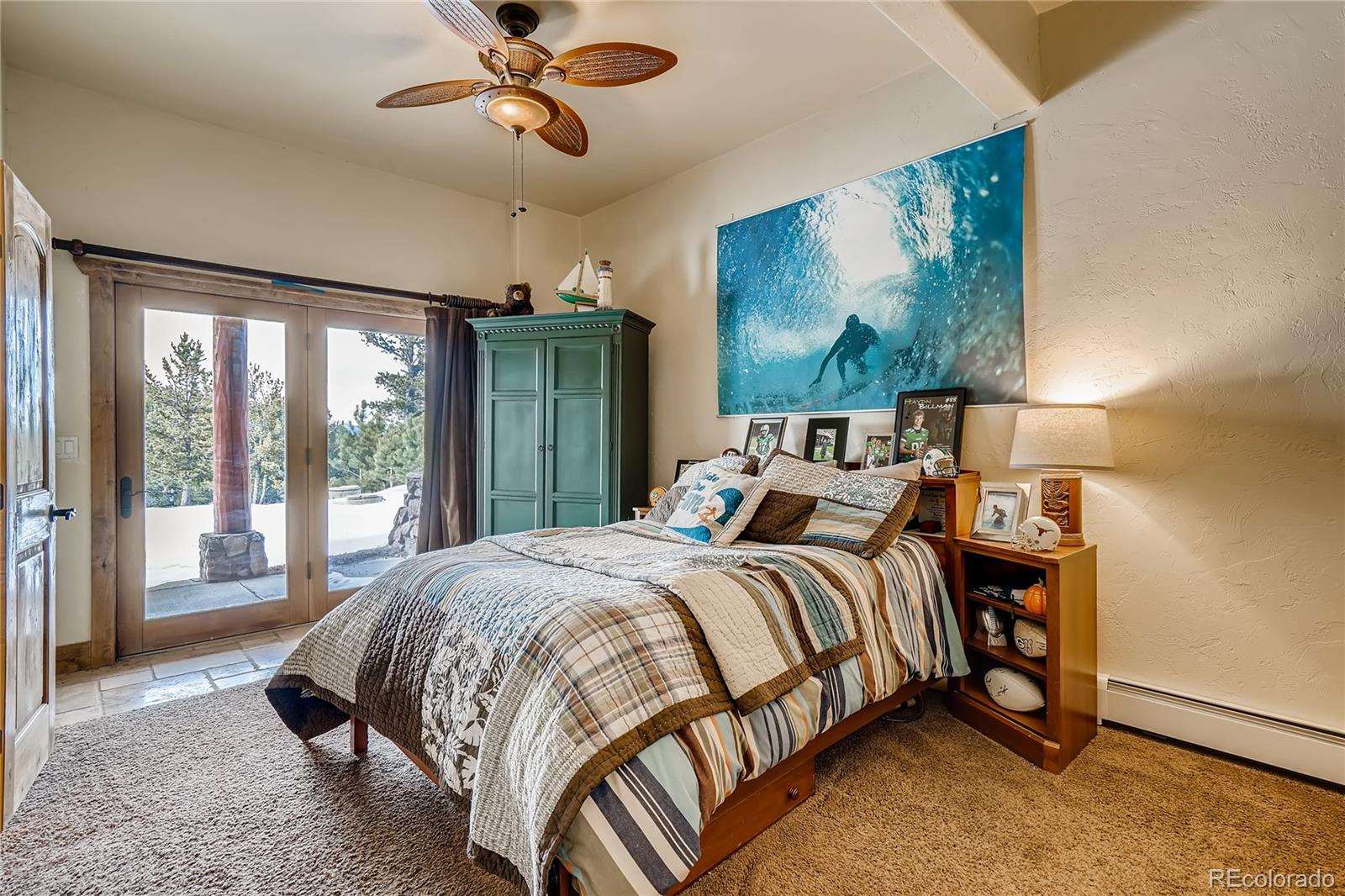 11200 Shimley Road Golden, CO 80403 - Photo 27 of 40 a bedroom with a bed mirror and window
