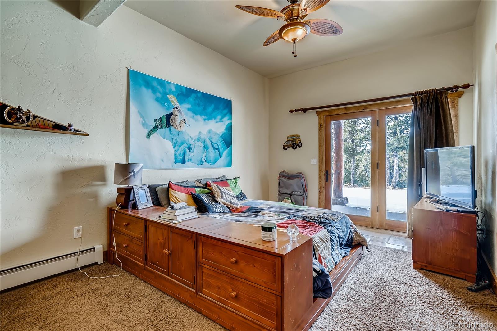 11200 Shimley Road Golden, CO 80403 - Photo 28 of 40 a bed room with a bed and a chandelier
