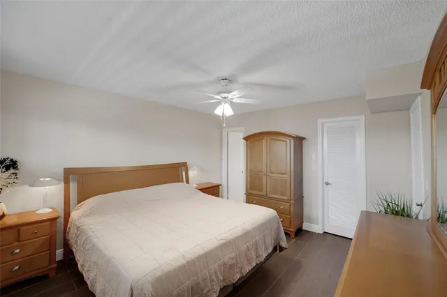 a room with lots of tables a large window and chairs