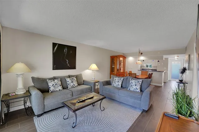 a living room with furniture and a lamp