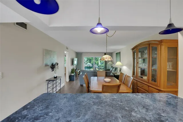 a kitchen with stainless steel appliances granite countertop a sink dishwasher and refrigerator