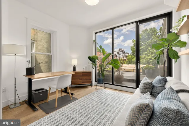 a bedroom with a bed and a large window with outer view