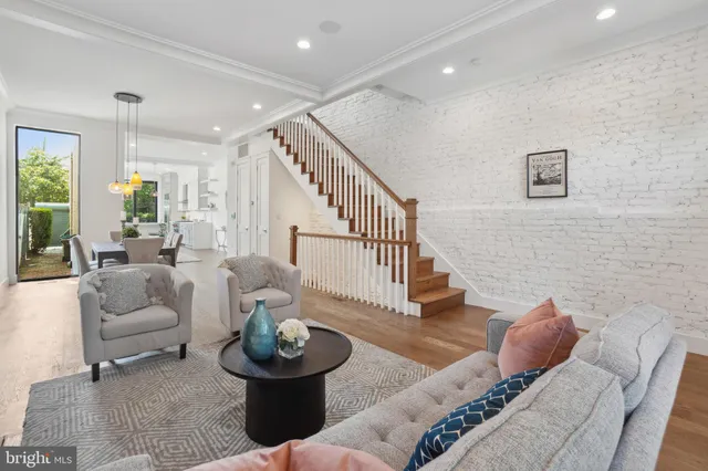a living room with couches and a dining table with garden view