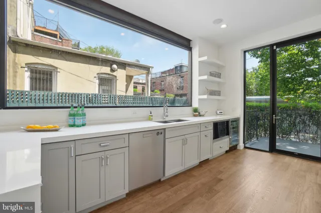 a spacious bathroom with a granite countertop sink and a large mirror