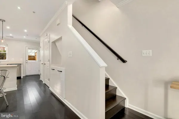 a view of entryway with wooden floor and stairs