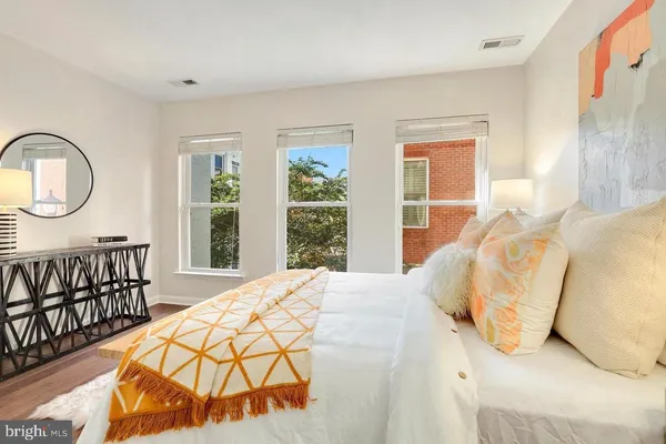 a bedroom with a bed with wooden floor