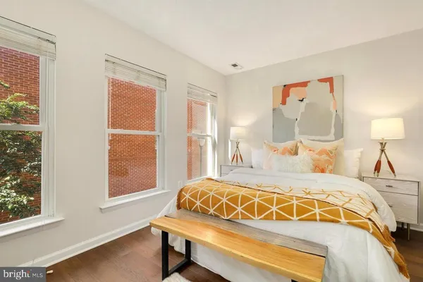 a bedroom with a bed and a window