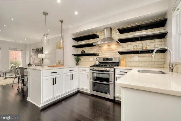 a kitchen with stainless steel appliances granite countertop a stove and a sink