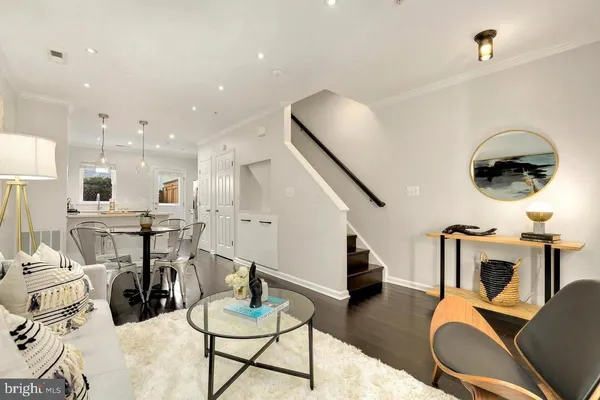 a living room with furniture and kitchen view
