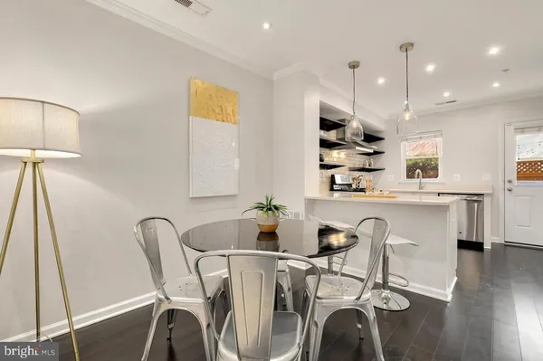 a dining room with furniture and wooden floor