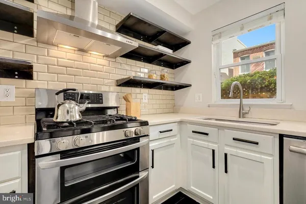a kitchen with a stove and a microwave