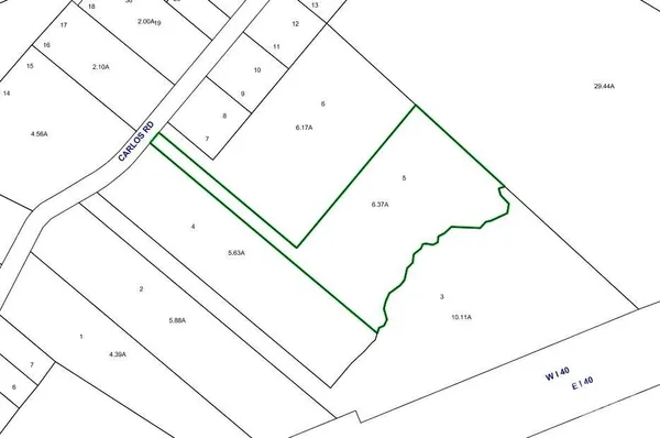 a view of dirt road with a building in the background