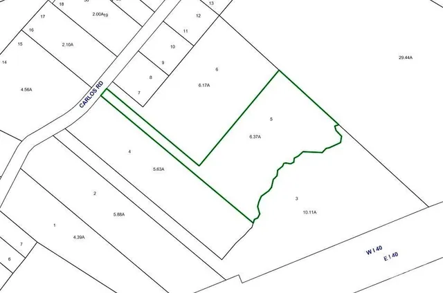 a view of dirt road with a building in the background