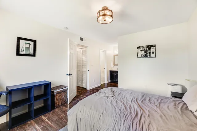 a bedroom with a bed and a table with bookshelf