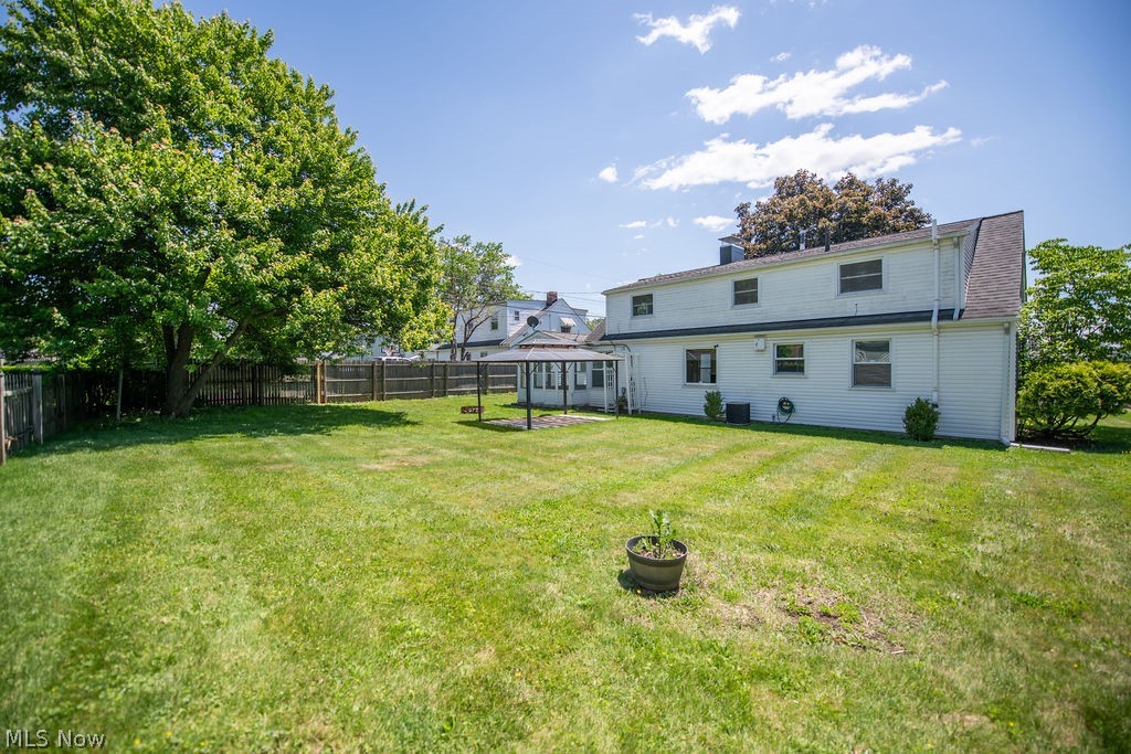 4221 2nd Street Northwest Canton, OH 44708 - Photo 5 of 35 Back exterior featuring 3 season sun room and patio