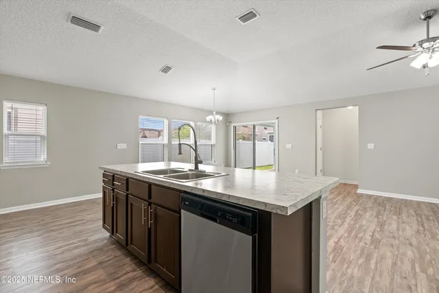 a kitchen with sink cabinets and wooden floor