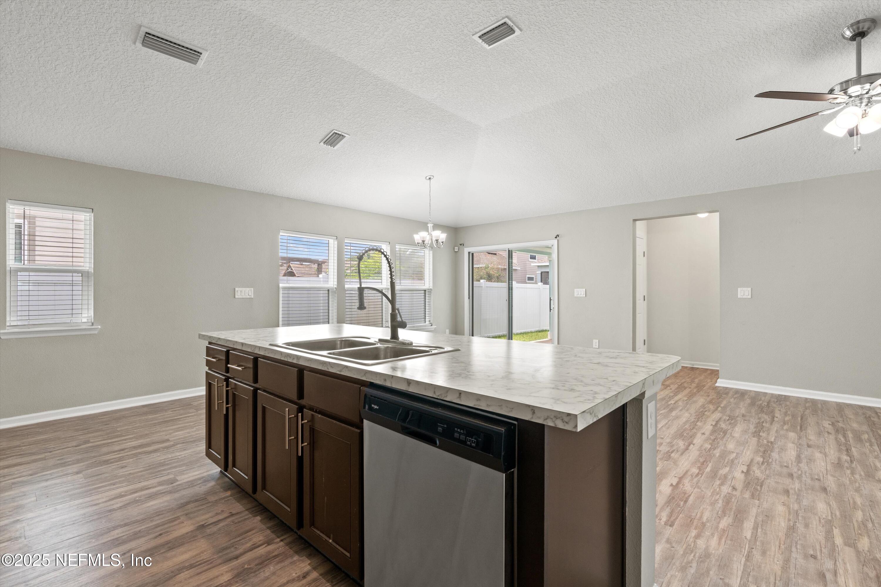 219 Bluejack Lane St. Augustine, FL 32095 - Photo 11 of 44 a kitchen with sink cabinets and wooden floor