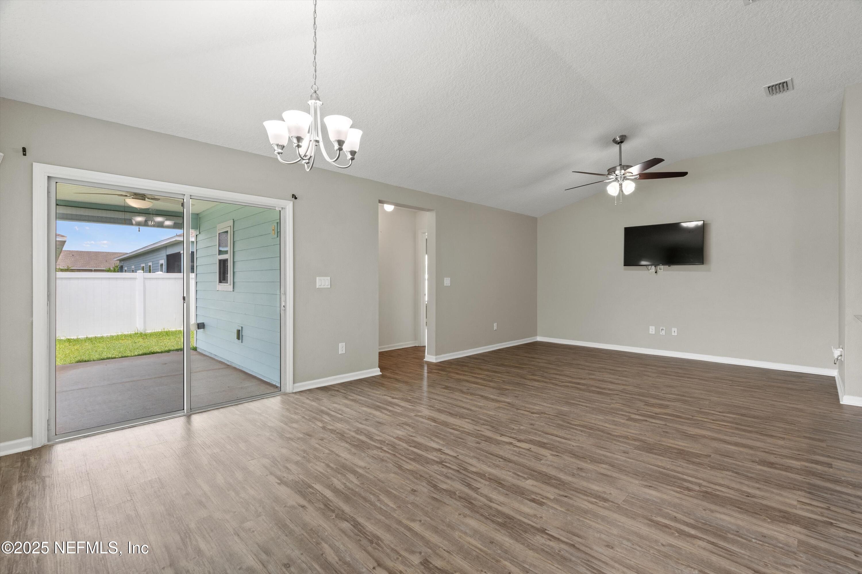 219 Bluejack Lane St. Augustine, FL 32095 - Photo 12 of 44 a view of an empty room with a window and wooden floor