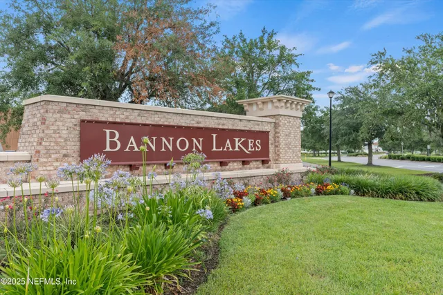 a sign that is sitting in front of flowers