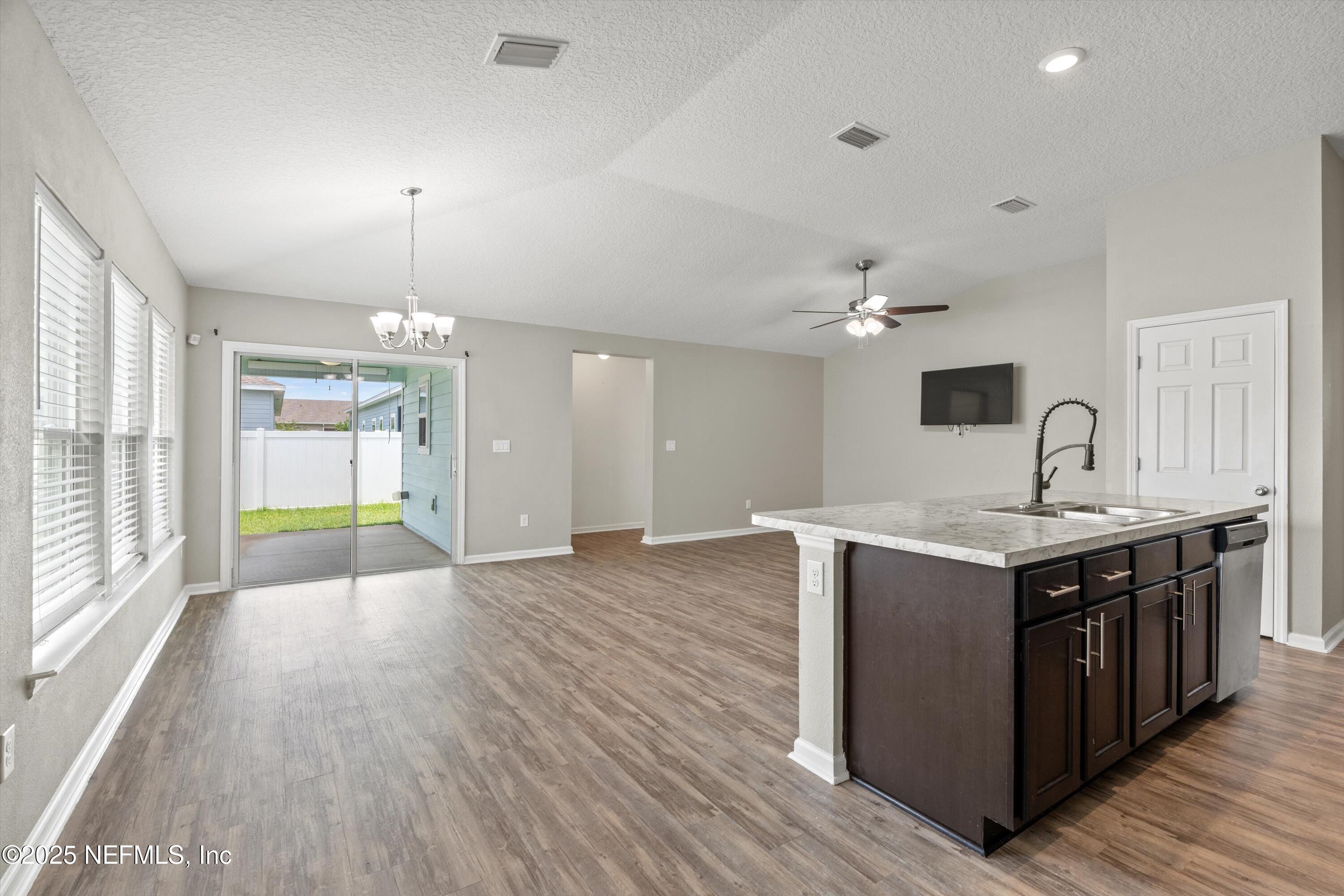 219 Bluejack Lane St. Augustine, FL 32095 - Photo 2 of 44 a kitchen with stove and wooden floor