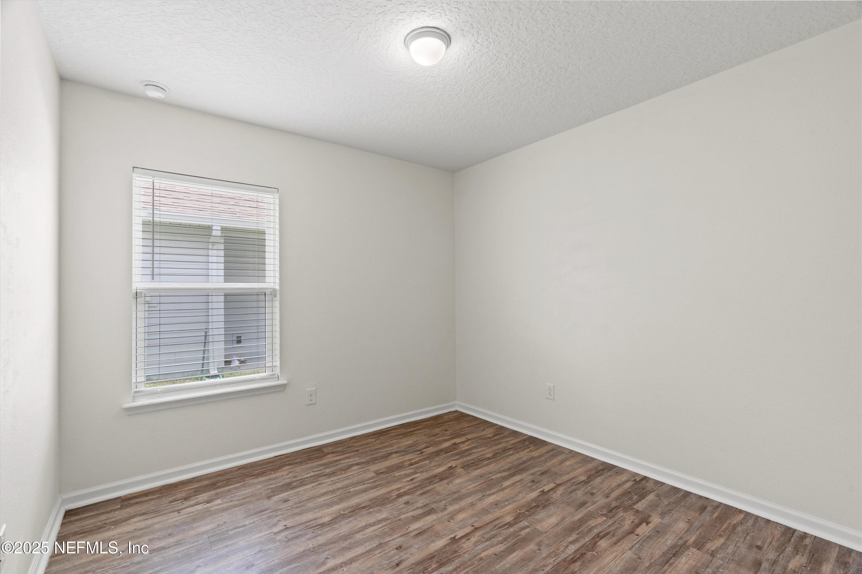 219 Bluejack Lane St. Augustine, FL 32095 - Photo 25 of 44 an empty room with wooden floor and windows