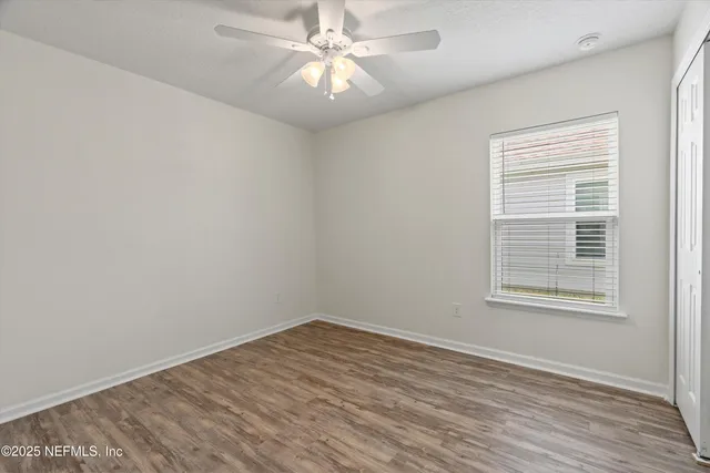 wooden floor in an empty room with a window