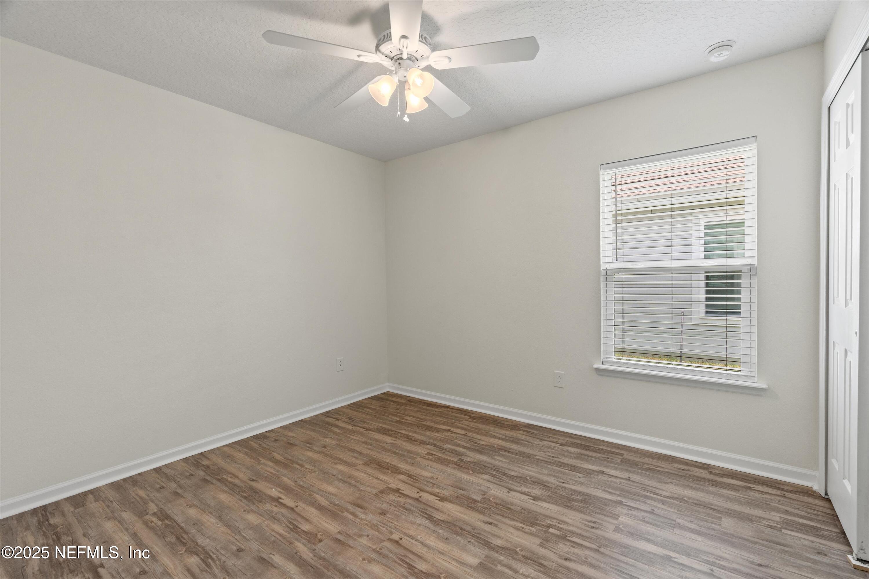219 Bluejack Lane St. Augustine, FL 32095 - Photo 28 of 44 wooden floor in an empty room with a window