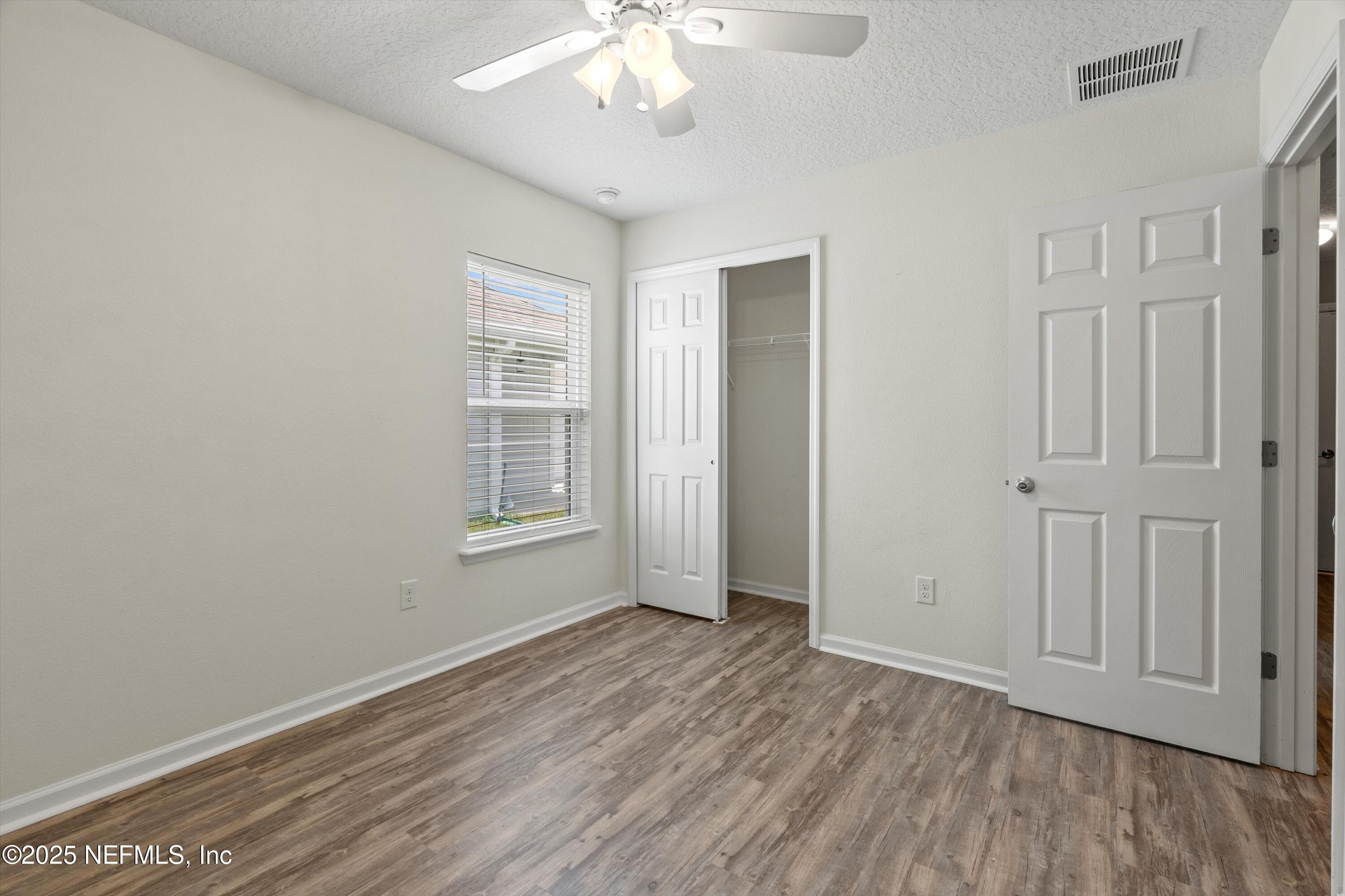 219 Bluejack Lane St. Augustine, FL 32095 - Photo 29 of 44 a view of an empty room with wooden floor and a window