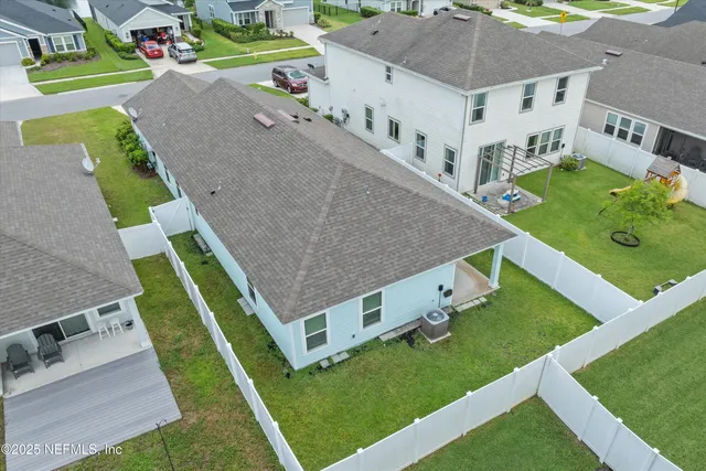 an aerial view of a house with a yard