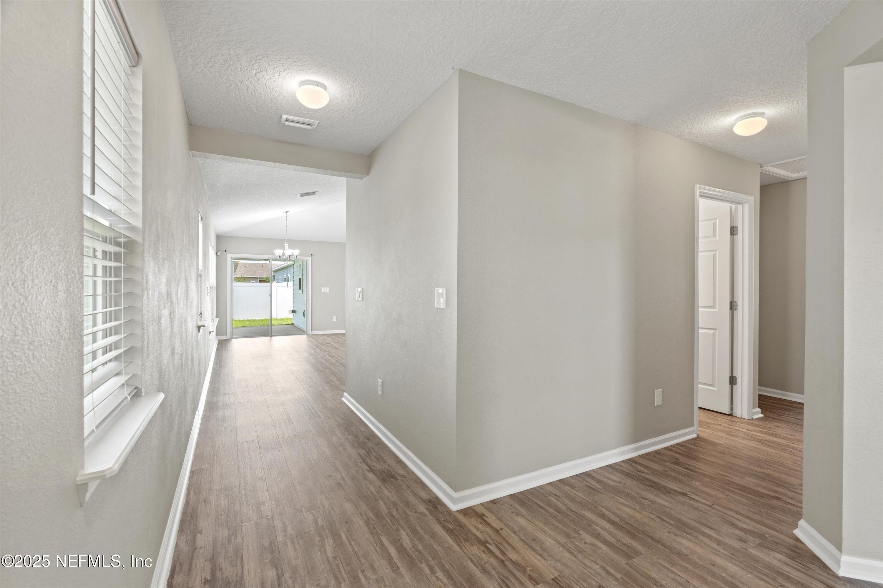 219 Bluejack Lane St. Augustine, FL 32095 - Photo 43 of 44 a view of a hallway with wooden floor