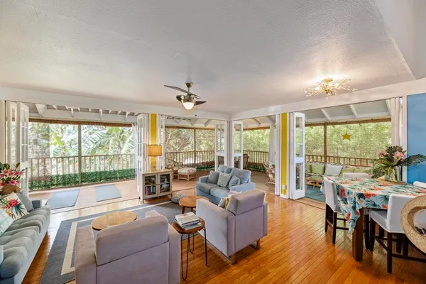 a living room with furniture and large windows