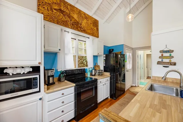 a balcony with couple of chairs and a couch