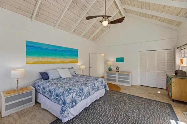 a bedroom with a bed a table and chair