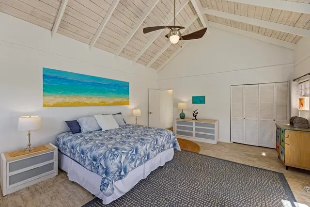 a bedroom with a bed a table and chair