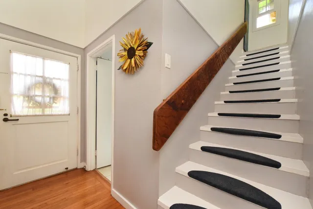 a bathroom with a granite countertop sink a toilet and a shower