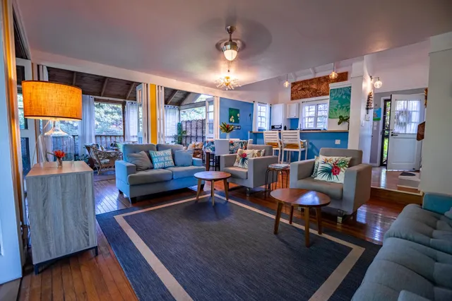 a spacious bedroom with a bed a window and dresser