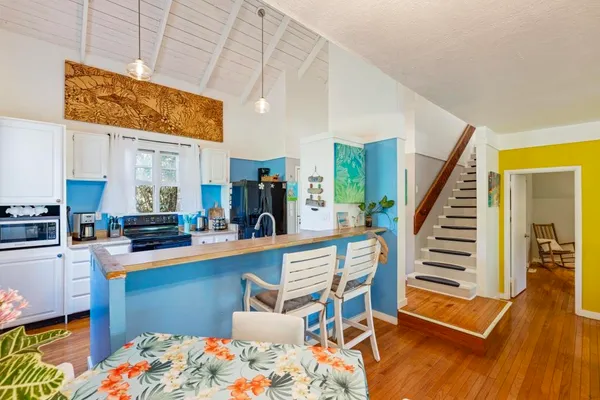 a kitchen with stainless steel appliances granite countertop a sink stove and cabinets