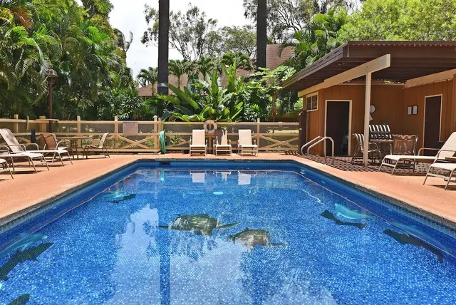 a view of swimming pool with chairs
