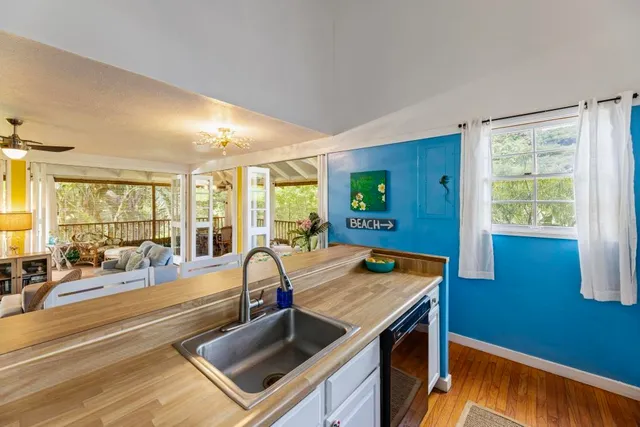 a living room with furniture and large windows