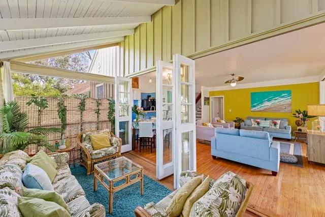 a living room with furniture and a floor to ceiling window