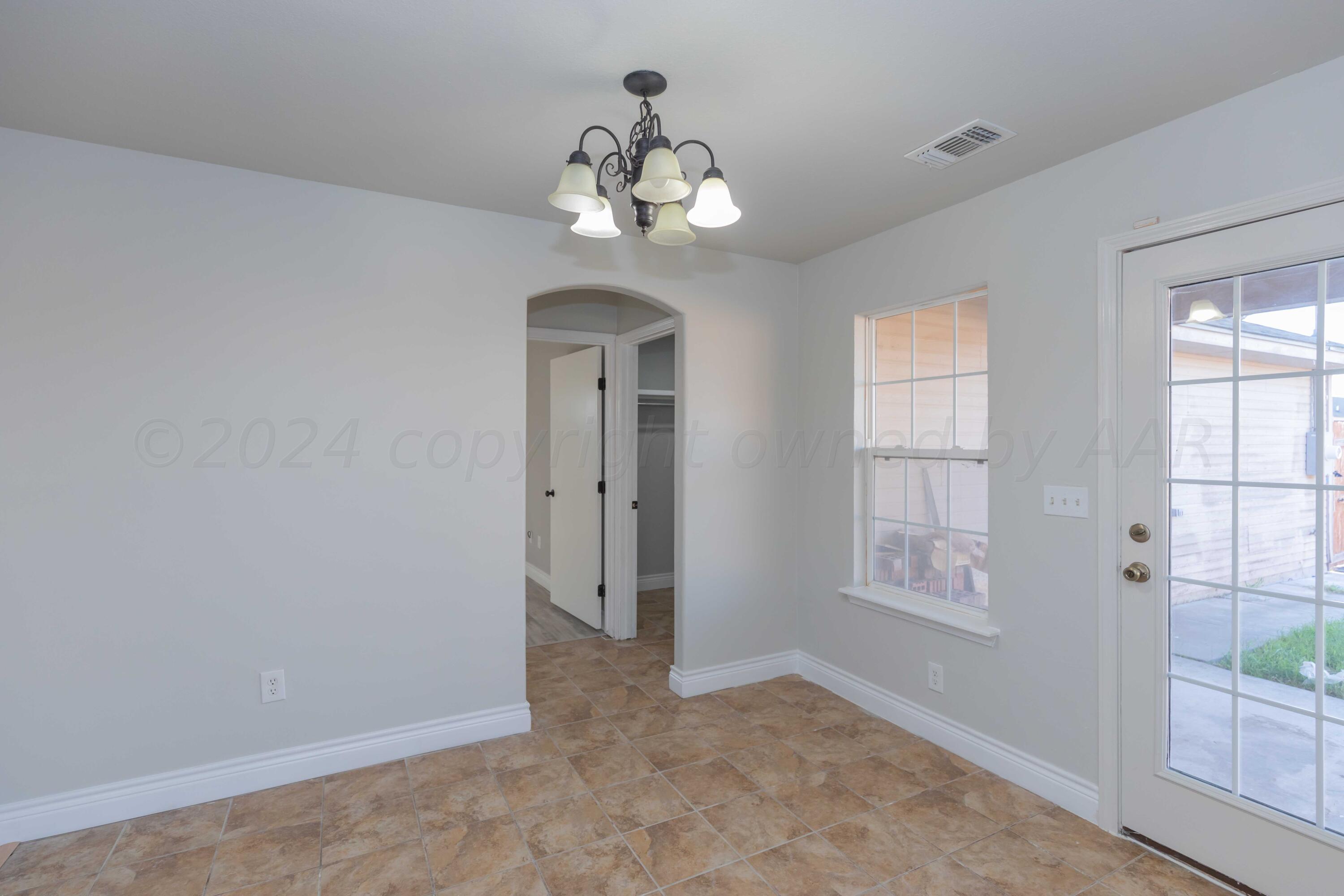 2805 Ries Lane Amarillo, TX 79118 - Photo 13 of 38 wooden floor in an empty room with a window