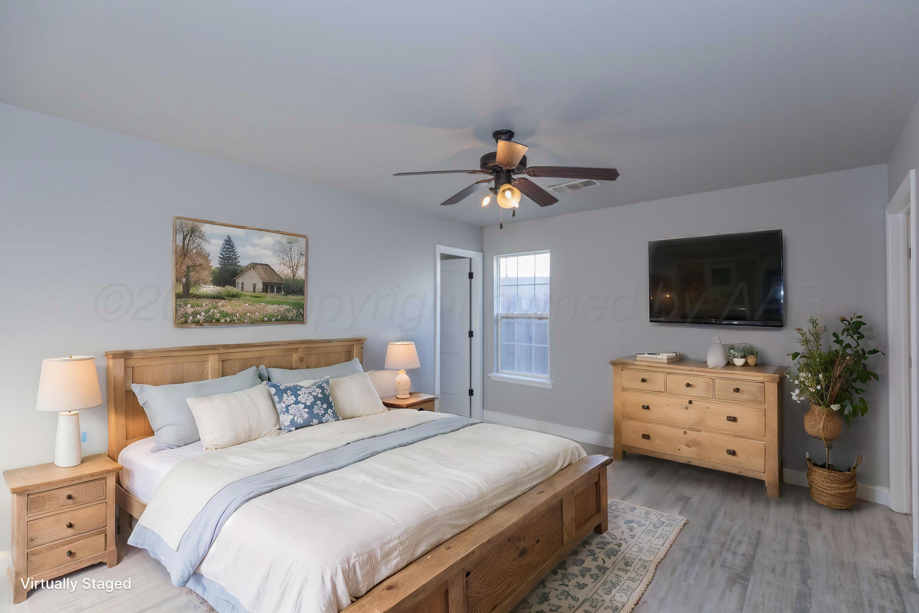 2805 Ries Lane Amarillo, TX 79118 - Photo 15 of 38 a bedroom with a bed and a flat screen tv