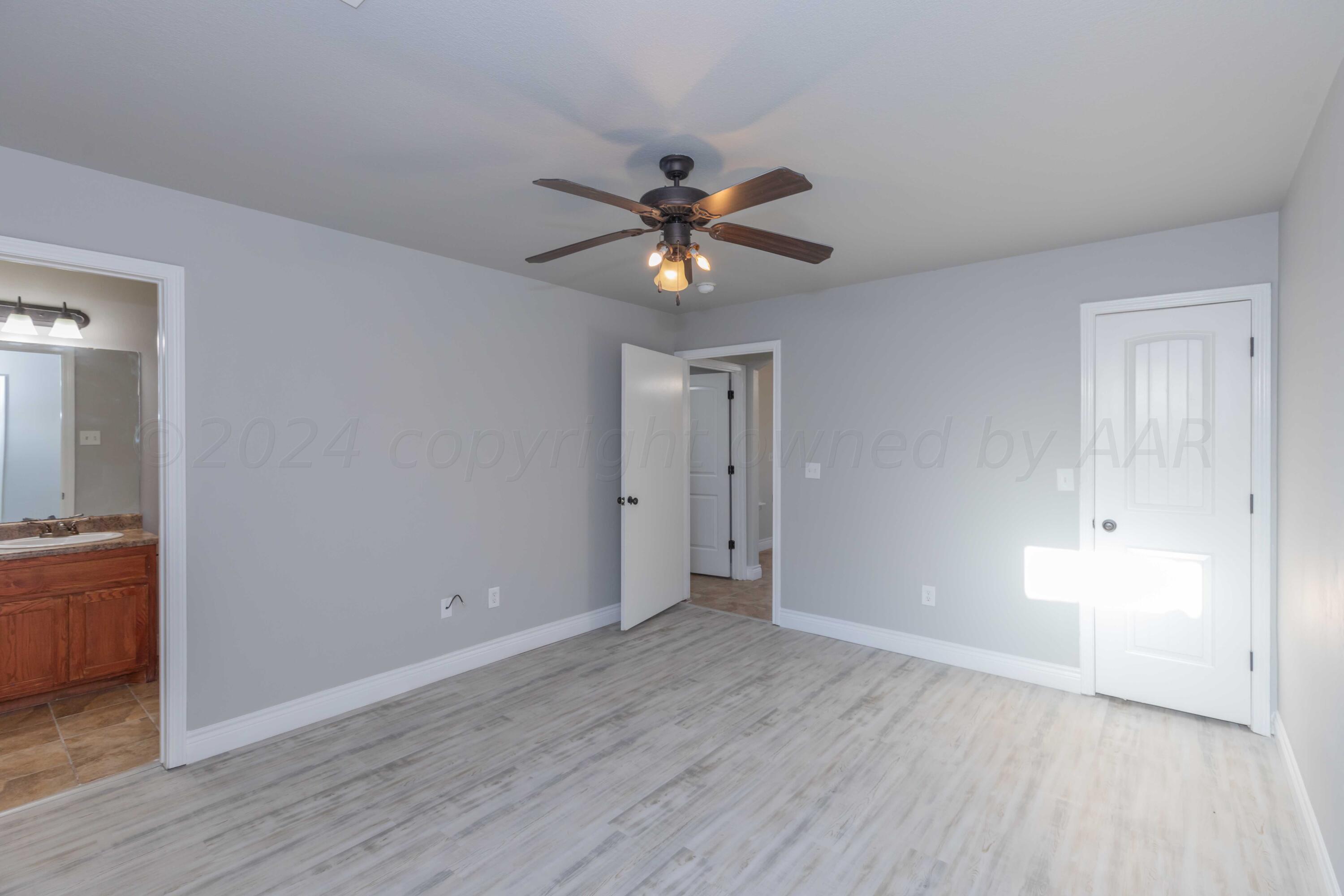 2805 Ries Lane Amarillo, TX 79118 - Photo 17 of 38 a view of an empty room and window and wooden floor