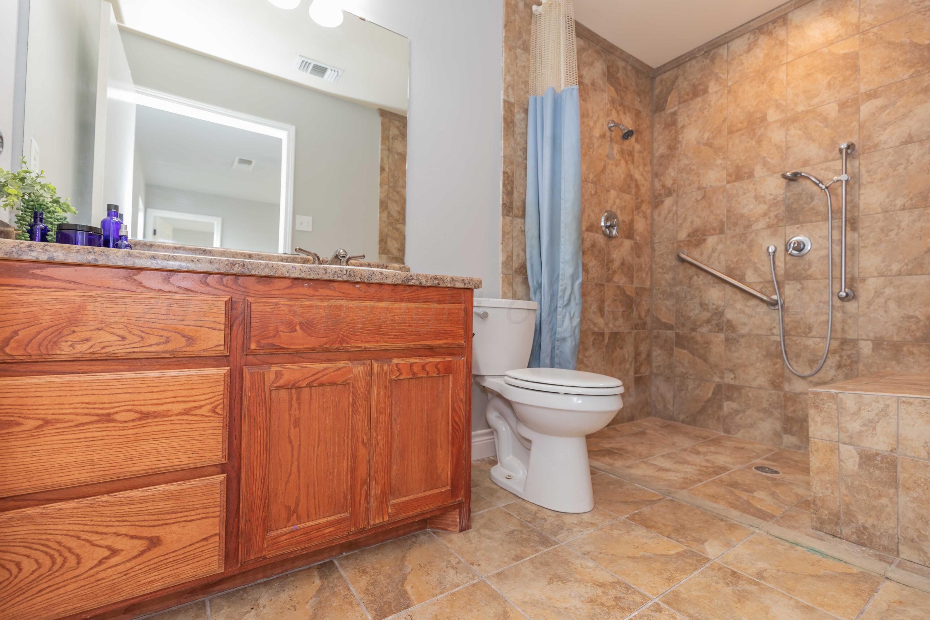 2805 Ries Lane Amarillo, TX 79118 - Photo 18 of 38 a bathroom with a toilet sink and a mirror