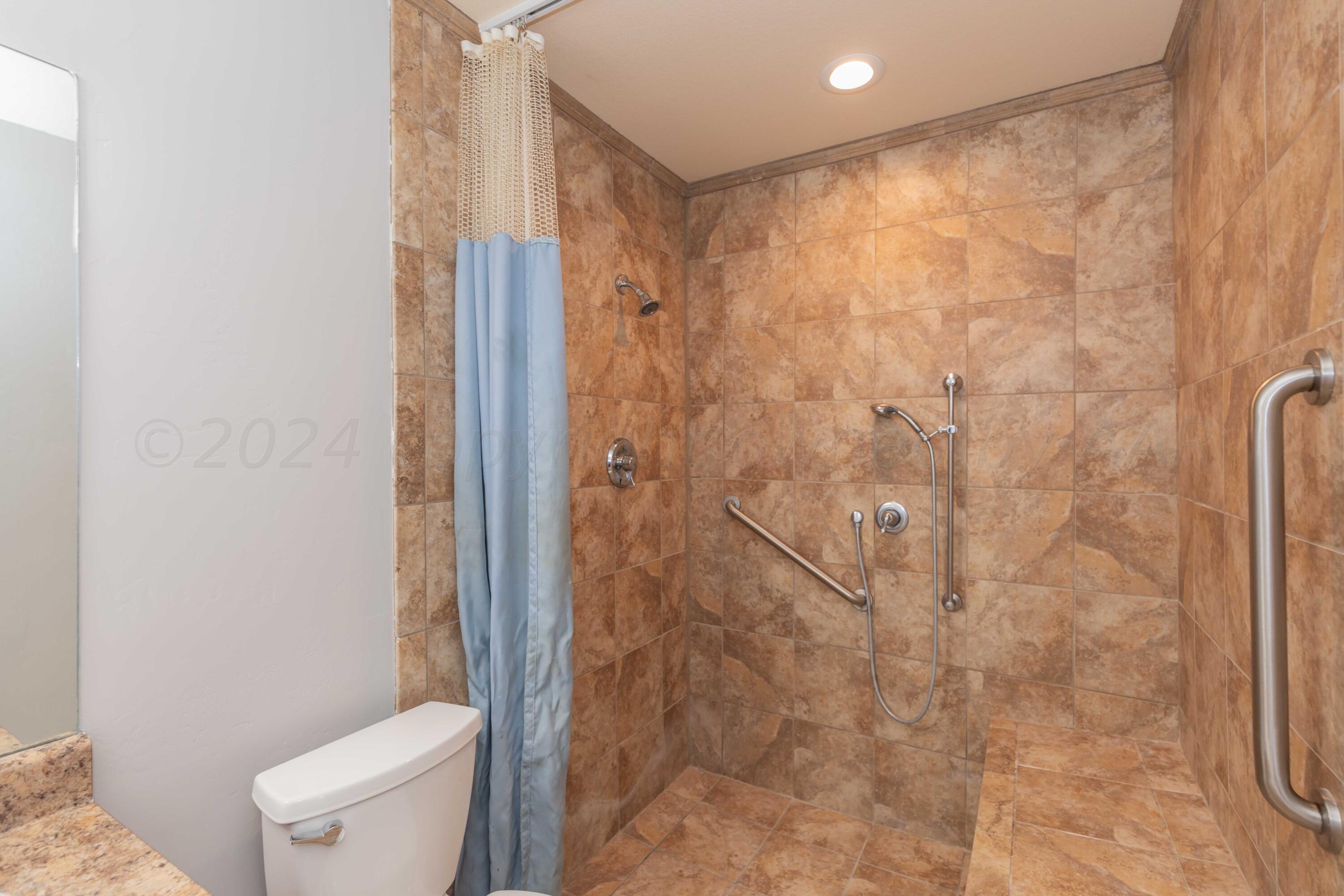 2805 Ries Lane Amarillo, TX 79118 - Photo 20 of 38 a bathroom with a shower and a toilet