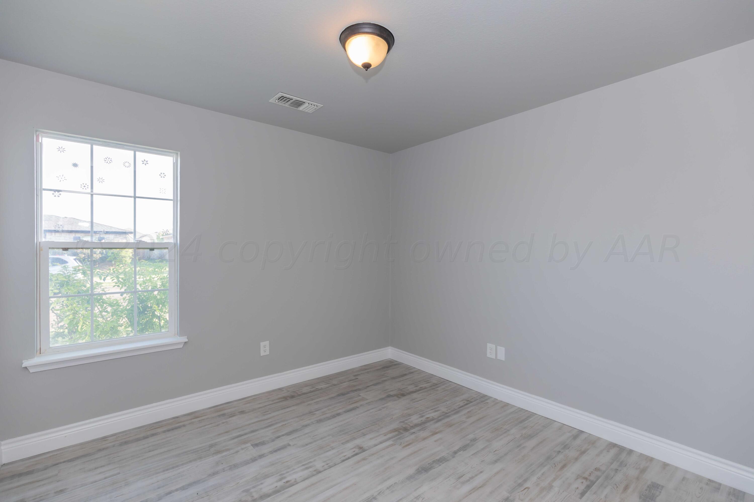 2805 Ries Lane Amarillo, TX 79118 - Photo 27 of 38 wooden floor in an empty room with a window